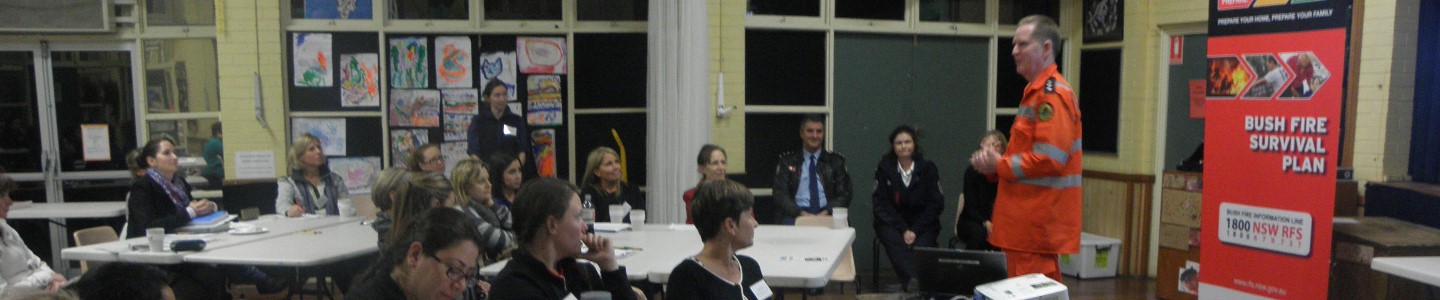 Rural fire service man talking about fire safety to a classrooom of adults
